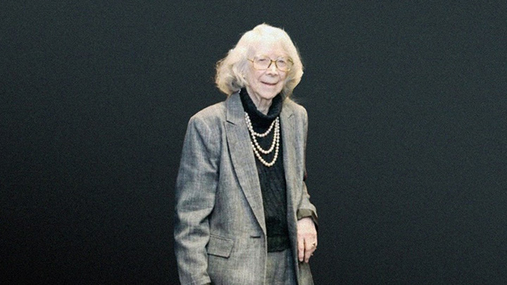 Elderly woman in a gray suit